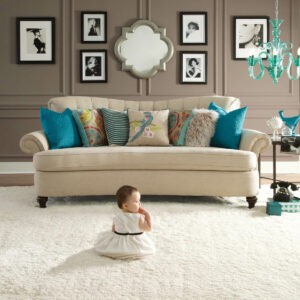 Cute baby sitting on carpet floor |  Mid-Michigan Floor Coverings