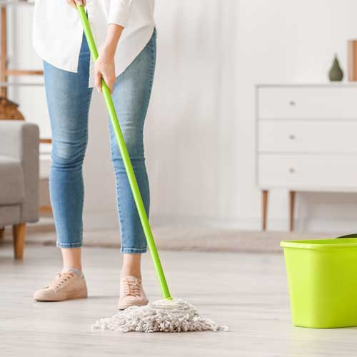 Lady cleaning floor | Mid-Michigan Floor Coverings